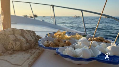 Tasting Cilento products on board a gozzo for a couple's experience in Campania Italy