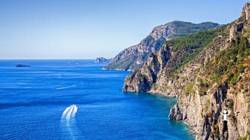 12-meter boat excursion focusing on the Marmorata waterfall and Pandora's Cave on the Amalfi Coast in Campania.