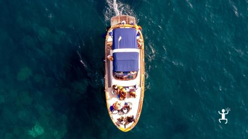 12-meter boat experience on the Amalfi Coast with stops for snorkeling activities.