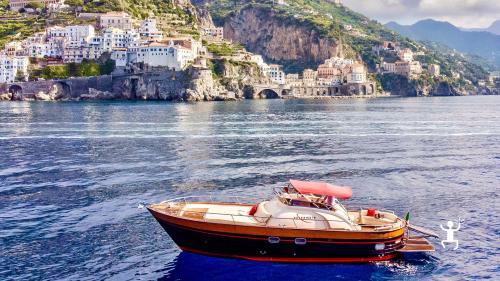 Explore the Amalfi Coast by boat with a skipper, including snorkeling, onboard aperitif, and lunch at a typical restaurant in Campania