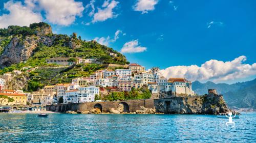 Boat sailing with opportunities for swimming and dolphin spotting at sunset, in Campania