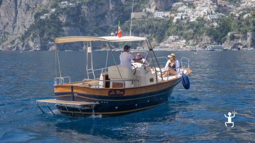 Onboard an exclusive boat until sunset to spot dolphins in Campania