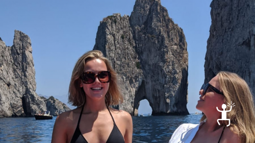 German girls visiting the faraglioni of Capri in inflatable boat