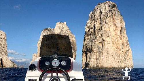 The faraglioni of Capri seen from very close with a stop in Campania