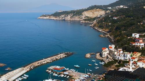 Landscape of Massa Lubrense in Sorrento Peninsula with port and bay for experience in Campania