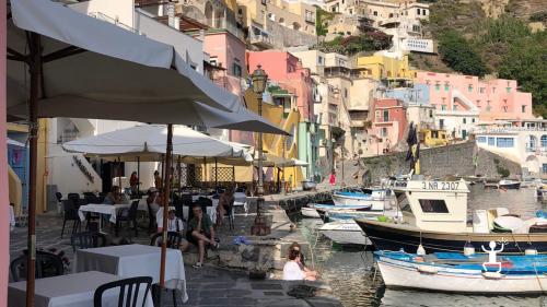 Procida Campania boat tour by experience with a stop at Corricella marina staring at its hundreds colors