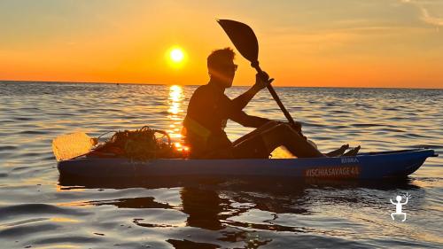 Experience Campania's island of Ischia while kayaking at sunset hour